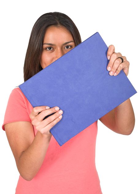 student with blue book over white