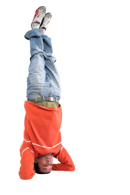 casual guy doing the headstand oevr a white background