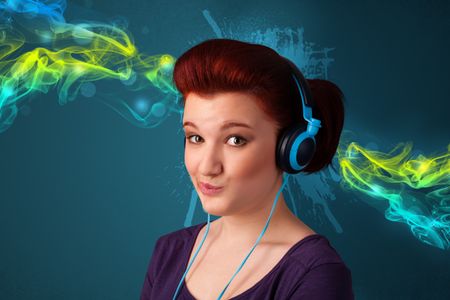 Pretty young woman with headphones listening to music, glowing smoke concept