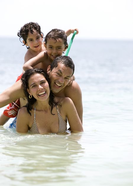 Happy family smiling and having fun at the beach