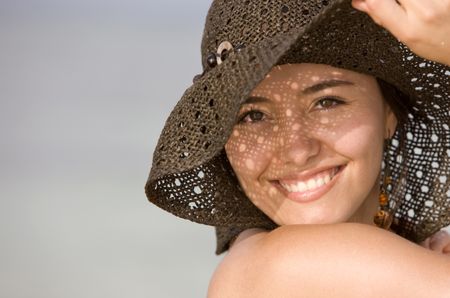 Beautiful beach girl portrait - smiling with hat