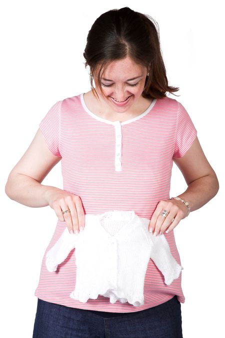 baby clothes over the belly of a pregnant woman