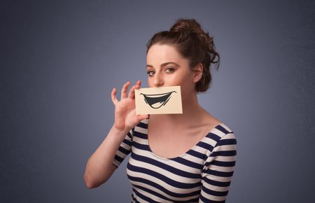happy-cute-girl-holding-paper-funny-174476216 Happy cute girl holding paper with funny smiley drawing on gradient background