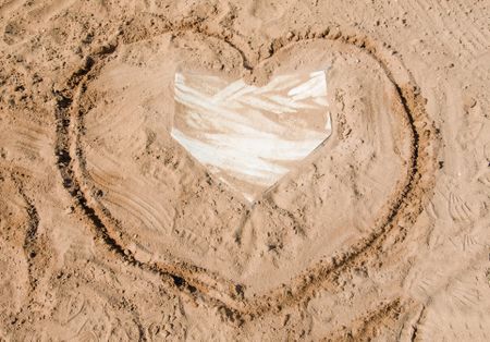 Heart shape drawn in sand around home plate on baseball field
