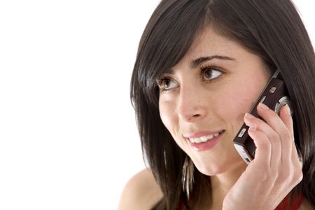 casual woman smiling and talking on a mobile phone - isolated over a white background