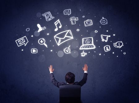 Young businessman sitting in office chair with sketched multimedia icons above his head