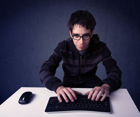 Hacker working with keyboard and mouse on blue background