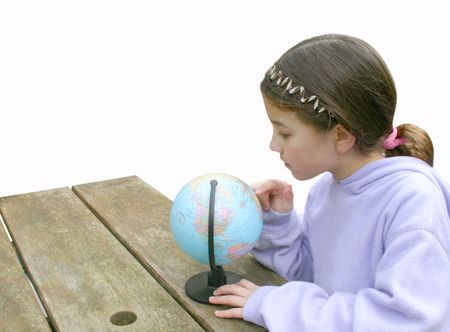 beautiful little girl exploring a globe