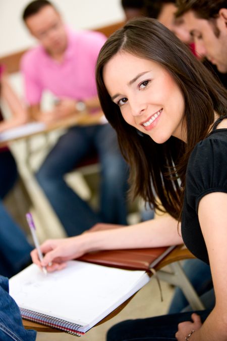 female university student making notes on a notebook