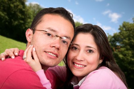 lovely couple outdoors in a park - big smile