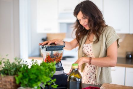 Health conscious woman using a blender