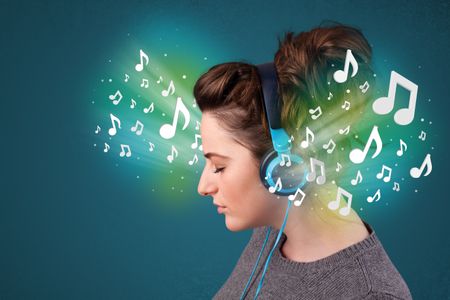 Pretty young woman with headphones listening to music, glowing notes concept