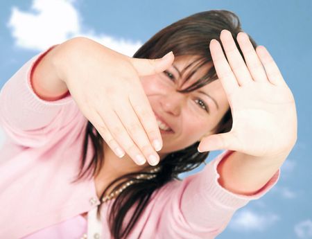 frame the fun - girl in pink with her hands in front with the sky in the background