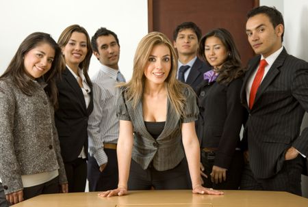 business woman smiling leading a team in an office