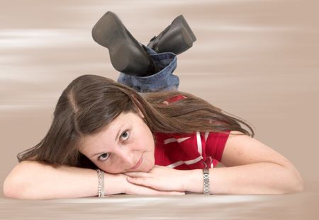 cute teen on the floor over a brown background