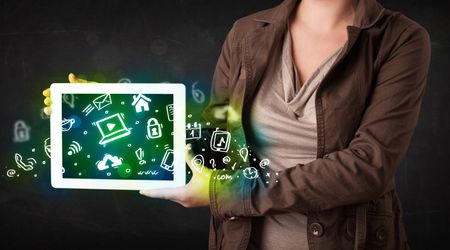 Person holding tablet pc with green media icons and symbols