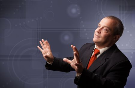 Elegant businessman standing and touching copy space