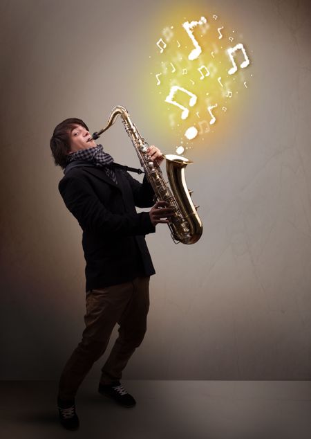 Handsome young musician playing on saxophone with musical notes