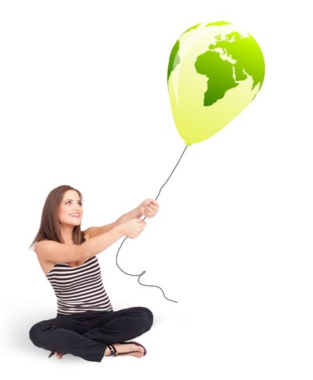 Happy young lady holding a green globe balloon