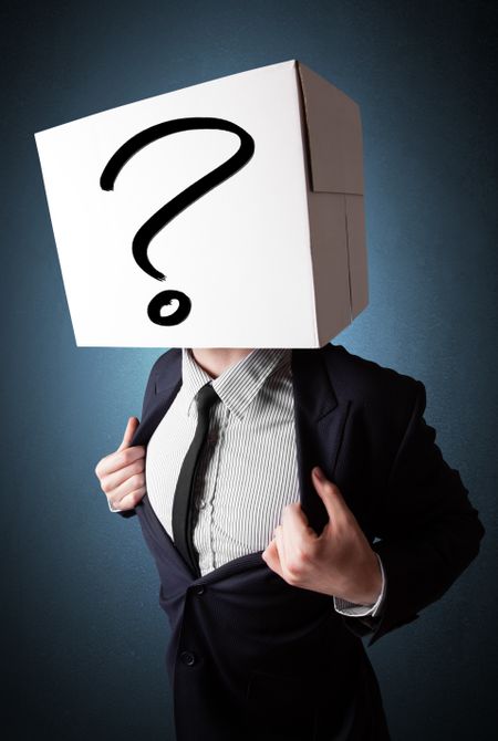Businessman standing and gesturing with a cardboard box on his head with question mark