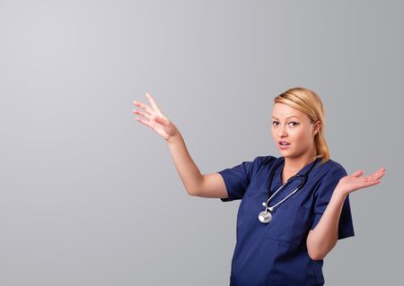 Pretty young female doctor gesturing with copy space