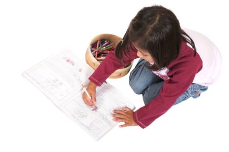 little kid drawing pictures on a notebook over white - focus on face