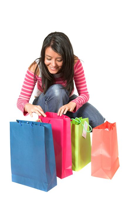 beautiful teenager with shopping bags over white