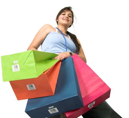 beautiful teenager with shopping bags over white taken from a low angle