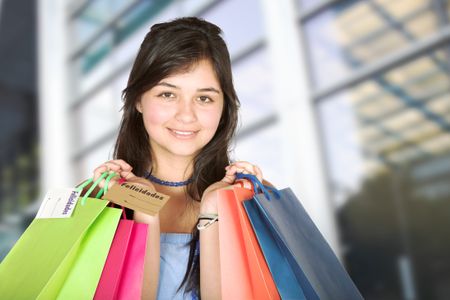beautiful teenager with shopping bags in a shopping mall