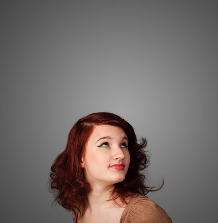 pretty-young-woman-gesturing-empty-space-186912500 Pretty young woman gesturing with empty space