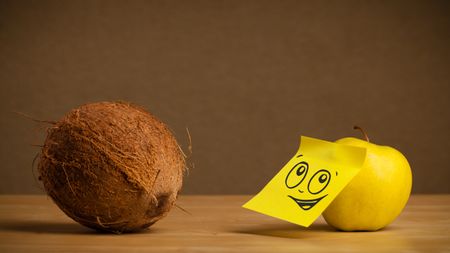 Apple with sticky post-it note reacting to coconut