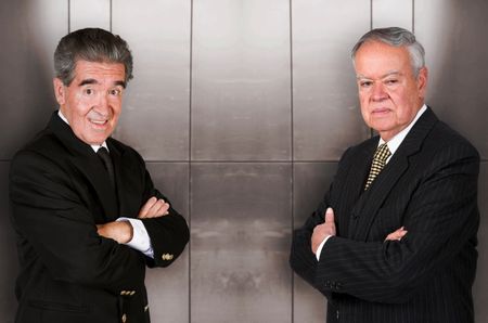 business duality - seniors over a metal wall