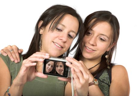 beautiful twins with digital camera over white