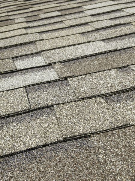 Asphalt roof shingles (foreground focus)