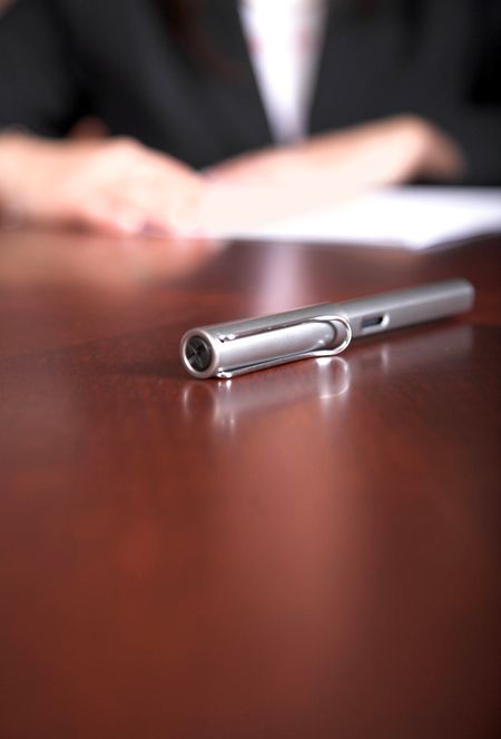 business pen on a desk - shallow depth of field - focus on pen