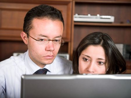 business couple on laptop in an office