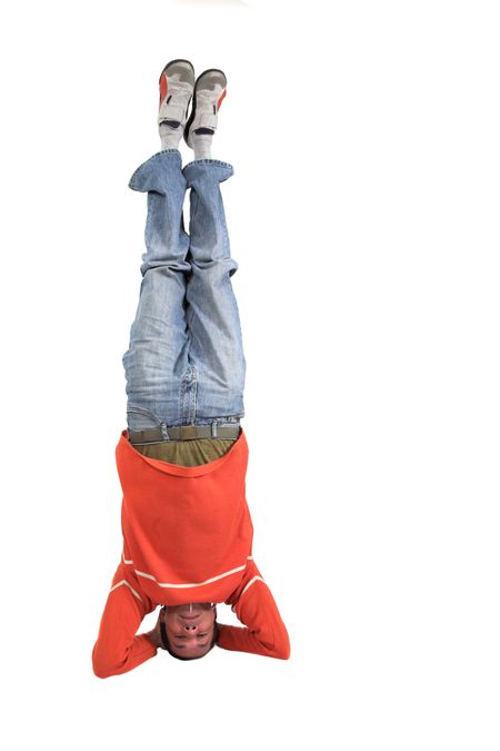 casual guy doing the headstand over white