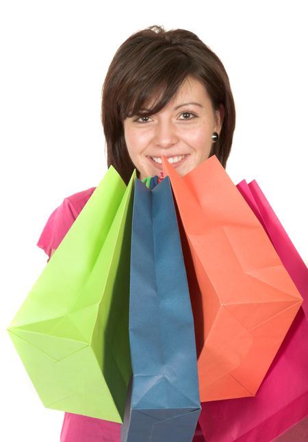 beautiful teenager with shopping bags over white - focus on bags