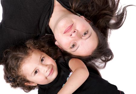 mother and daughter on the floor over white