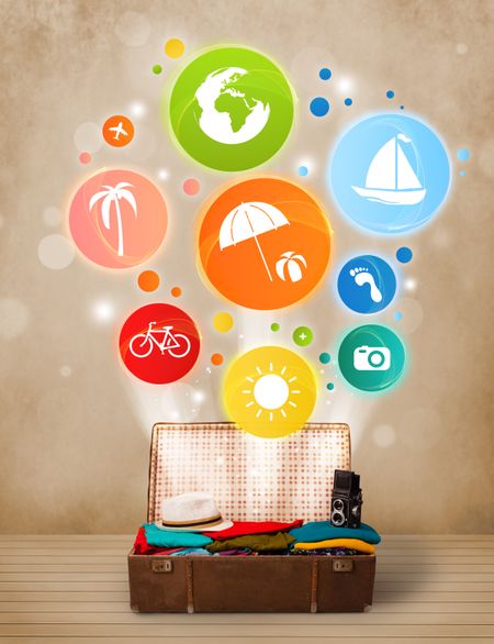 Suitcase with colorful summer icons and symbols on grungy background