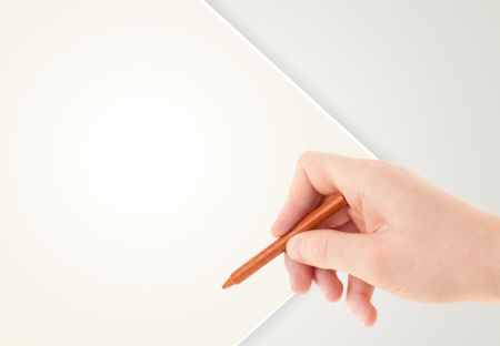 Child drawing with colorful crayon on empty plain blank paper