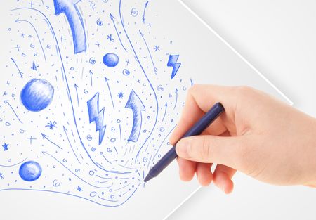 Hand drawing abstract sketches on a plain white paper
