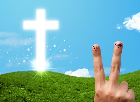 Happy finger smiley faces on hand with christian religion cross