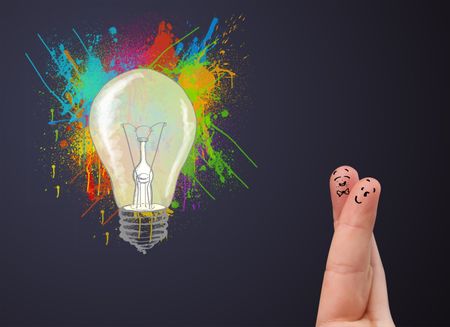 Happy cheerful smiley fingers looking at abstract hand drawn colorful lightbulb