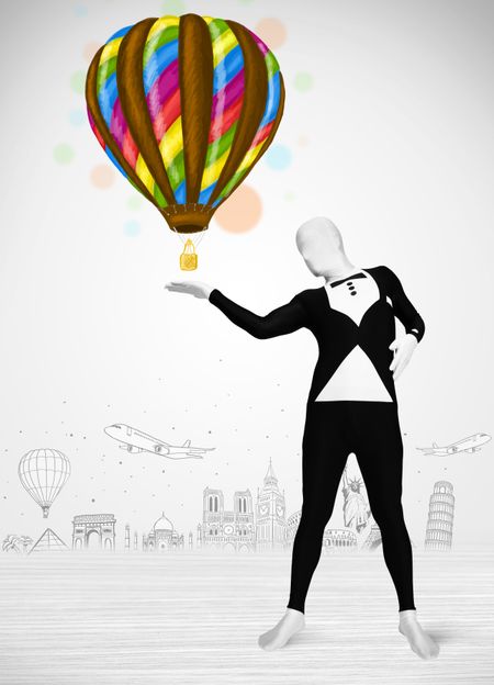 Funny man in full body suit holding colorful balloon, tourist attractions in background