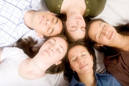 friends with heads together while sleeping on the floor - soft focus