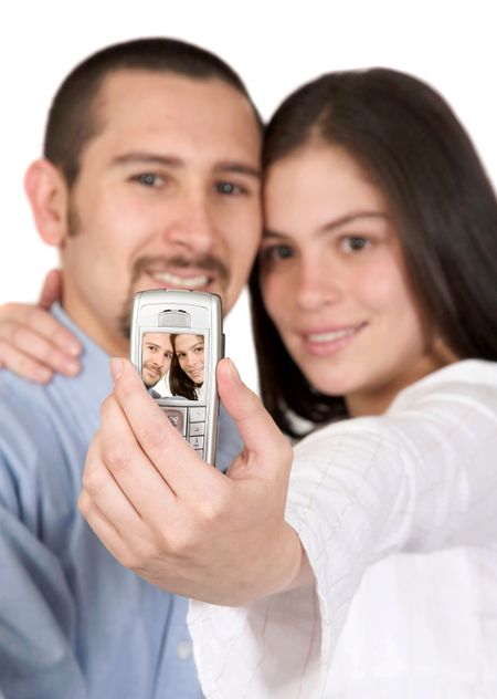 casual couple taking a pic with their mobile phone over white