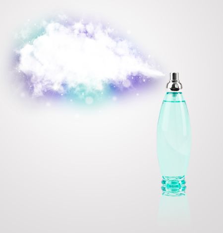 women's perfume in beautiful bottle spraying colorful cloud, copyspace in cloud