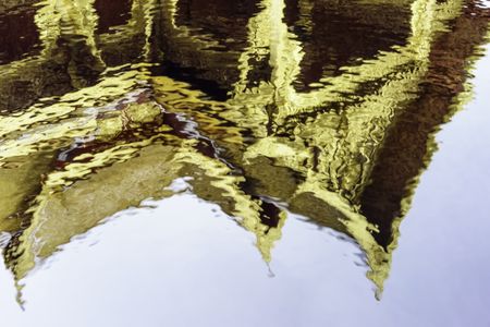 Aquatic abstract: Reflection of gilded pavilion in slightly rippled pool