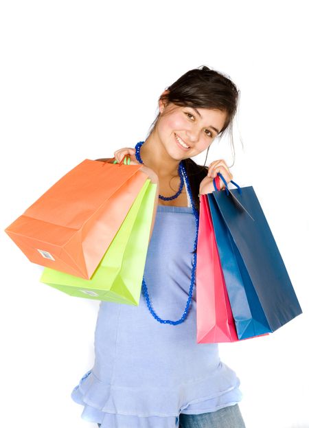 beautiful teenager with shopping bags over white